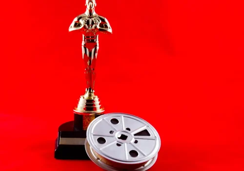 New Cumberland, PA, USA - February 3, 2015 : Illustrative editorial showing the Academy Awards statue known as Oscar with an old time movie reel on the iconic red carpet